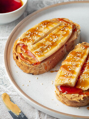 Tasty toast for breakfast with peanut butter banana and honey. Close up food photo