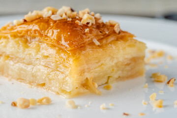 Turkish baklava with hazelnuts on a white porcelain plate