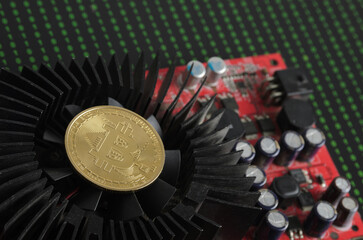 A bitcoin gold coin on a cooling fan against the background of binary code