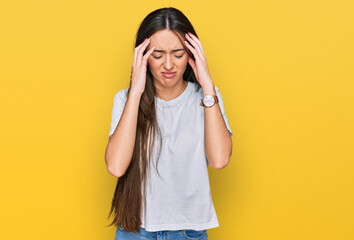 Young hispanic girl wearing casual white t shirt with hand on head, headache because stress. suffering migraine.