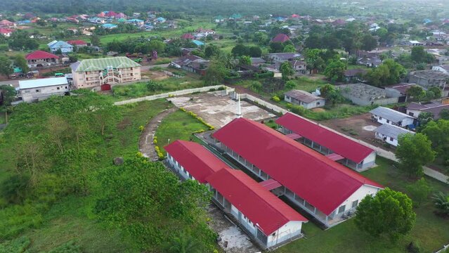 Aerial Bo city church homes Sierra Leone circle fast. West Africa suffers extreme poverty and hunger. Congested crowded homes and businesses. Tropical climate forest, jungle, mountain and savanna.