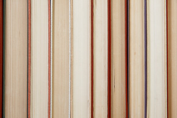 Composition with vintage old hardback books, diary, fanned pages on wooden deck table and colored background. Books stacking. Back to school. Copy Space. Education background.