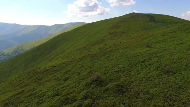 Aerial flight over green hill mountains. FPV Dynamic drone shot