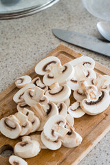 sliced mushrooms on a wooden board. Chopped champignons