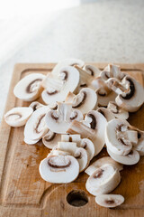 sliced mushrooms on a wooden board. Chopped champignons