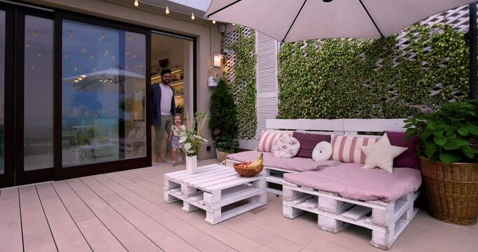 happy father and daughter open the sliding doors, going out on garden terrace