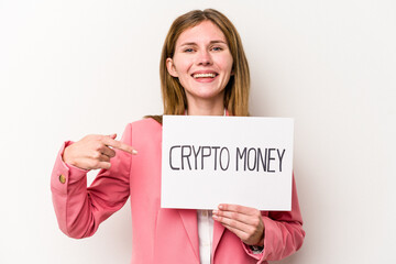 Young English business woman holding a crypto money placard isolated on white background person pointing by hand to a shirt copy space, proud and confident
