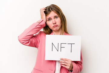 Young English woman holding a NFT placard isolated on white background being shocked, she has remembered important meeting.