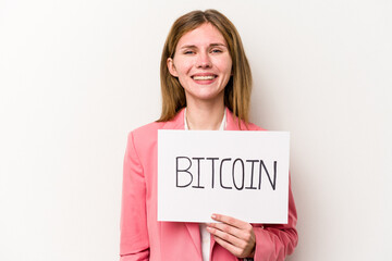 Young English business woman holding a bitcoin placard isolated on white background happy, smiling and cheerful.