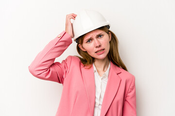 Young architect English woman with helmet isolated on white background being shocked, she has remembered important meeting.