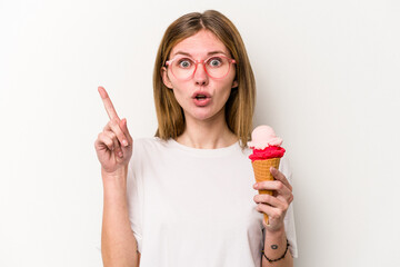 Young English woman holding an ice cream isolated on white background having some great idea, concept of creativity.