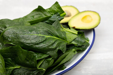 fresh green spinach on dish on ceramic