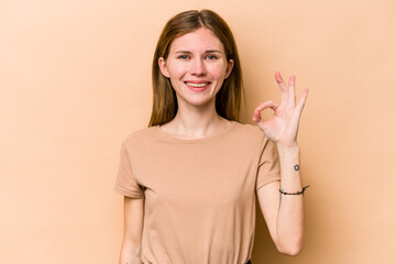 Young English woman isolated on beige background cheerful and confident showing ok gesture.