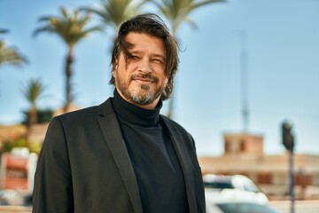Fototapeta premium Middle age businessman smiling happy standing at the city.