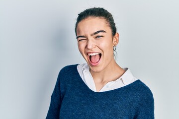 Young caucasian girl wearing casual clothes winking looking at the camera with sexy expression,...