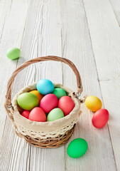 Fototapeta na wymiar Basket full with colorful Easter eggs