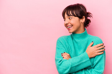 Fototapeta premium Young hispanic woman isolated on pink background smiling confident with crossed arms.