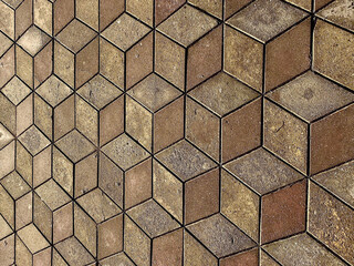 Mosaic tile pavement background. Footpath made by square tiles with illusion perspective. Cubes...