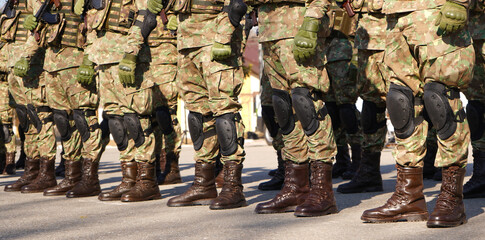 soldiers in formation. photo during the day. details. - obrazy, fototapety, plakaty