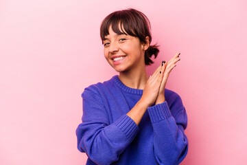 Young hispanic woman isolated on pink background feeling energetic and comfortable, rubbing hands confident.