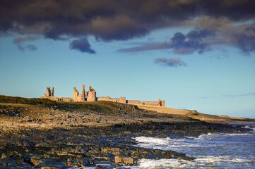 Dunstanburgh Castle viewed from Craster, part of the coastal section on the Northumberland 250, a scenic road trip though Northumberland with many places of interest along the route