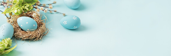 pastel blue easter eggs in bird nest on blue background. copy space for text - 487096480