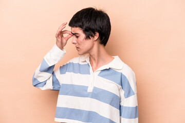 Young caucasian woman isolated on beige background having a head ache, touching front of the face.