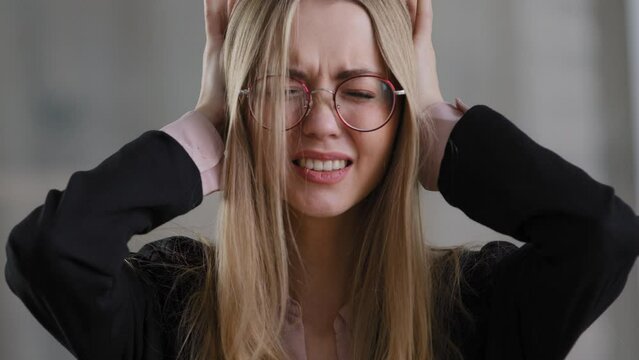 Caucasian tired female sad student girl wearing glasses stressed business woman in despair lady covering ears with hands refusing to listen disagreement shaking head no stress pressure grief problems