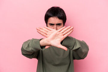 Young caucasian woman isolated on pink background doing a denial gesture