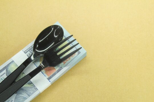 spoon and fork on the money. food tip concept