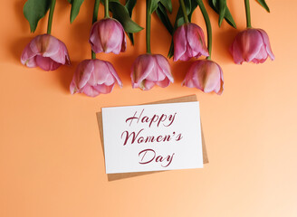 Postcard with text Happy Women's Day and tulips on a yellow background. Women's day greeting card...
