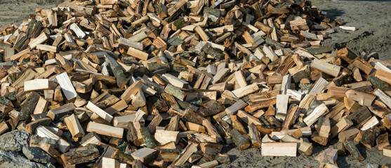 Pile of dry chopped firewood outdoors