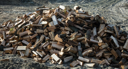Pile of dry chopped firewood outdoors