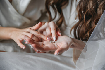 The ring is examined. Holds a ring. Wedding ring in hands
