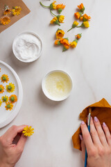 Confectioner is hands make crystallized flowers. Candied edible flowers with egg whites and sugar....