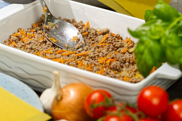 Woman preparing meat lasagna in kitchen. Italian food. lasagna recipe