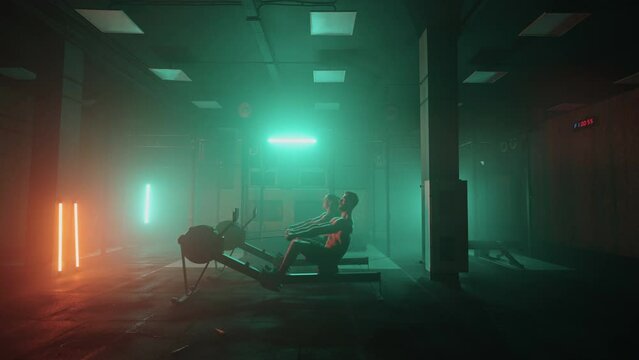 A man and a woman in a colored neon red and blue light do a workout on a rowing simulator together. Strong man and woman
