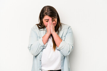 Young caucasian overweight woman isolated on white background praying, showing devotion, religious person looking for divine inspiration.