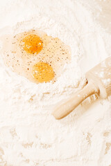 Cooking homemade dough, flour and eggs on the table. Rolling pin and pepper on eggs. Cooking at home, recipes, diet