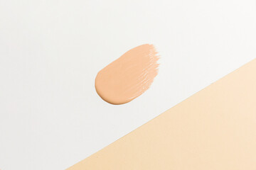 Tonal care products, makeup, smudged color products. Foundation color option on white and beige...