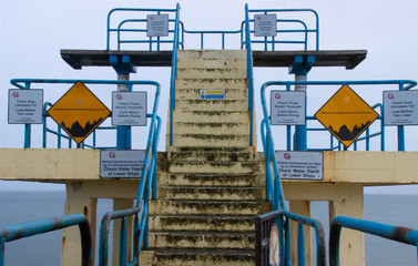 multiple warning signs on a diving platform stage