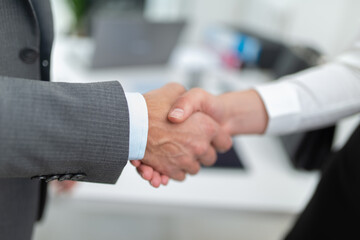 People shaking hands in an office