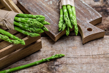 Asparagus. raw stems of asparagus on a wooden background. Long banner format, top view