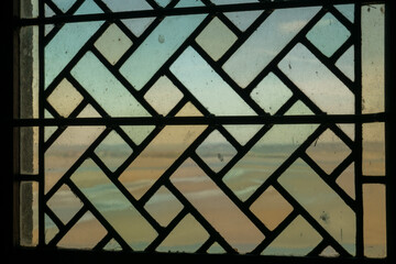 Stained glass window in Mont Saint Michel abbey, Normandy, France 02/2022