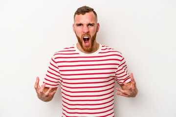 Young caucasian man isolated on white background screaming with rage.