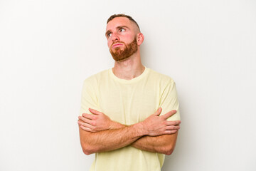 Young caucasian man isolated on white background tired of a repetitive task.