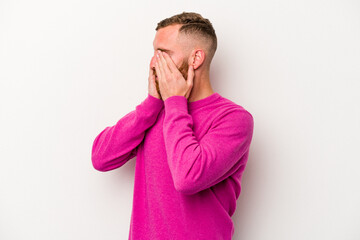 Young caucasian man isolated on white background afraid covering eyes with hands.