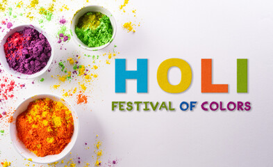 Happy Holi decoration, the indian festival.Top view of colorful holi powder with the text on white background.