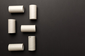 Flat lay composition with empty toilet paper rolls and space for text on color background. Recyclable paper tube with metal plug end made of kraft paper or cardboard