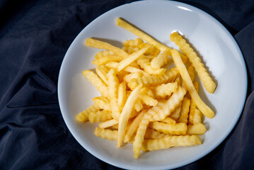 French fries in a plate French fries in a plate. on a dark background .